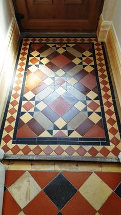 an old tiled floor in the corner of a room