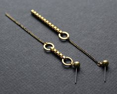 These cool asymmetrical earrings features cool chunky chain and a great geometric feel as well! * Sturdy brass cube chain, textured * Brass circle links * Black plated faceted brass chain * Brass ball studs * Plastic stoppers included Mesures a little over 3.25in (83mm) from top to bottom. Also available in turquoise: https://www.etsy.com/ca/listing/659567314/ As well as pink: https://www.etsy.com/ca/listing/659595570/ Also see these in a symmetric version! :) https://www.etsy.com/ca/listing/640 Minimalist Metal Linear Earrings With Adjustable Chain, Plastic Stoppers, Brass Circle, Jewelry Holders, Earrings Chain, Asymmetrical Earrings, Unusual Earrings, Mismatched Earrings, Black Plates