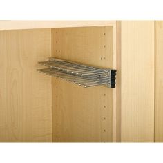 a close up of a metal rack in a wooden cabinet