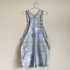 Vintage short overalls with hand painted flowers, patches, and embroidery. Cotton Denim Blue Shortalls For Spring, Spring Cotton Denim Blue Shortalls, Spring Cotton Shortalls In Medium Wash, Spring Light Wash Cotton Shortalls, Spring Medium Wash Cotton Shortalls, Bohemian Cotton Overalls For Spring, Spring Washed Shortalls Overalls, Spring Denim Blue Shortalls, Vintage Cotton Shortalls For Spring