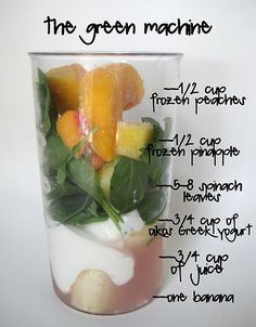 a cup filled with fruit and vegetables on top of a table