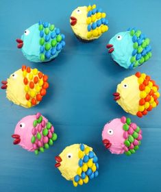 rainbow fish cupcakes on a blue background with the words rainbow fish cupcakes