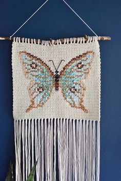 a blue wall hanging with a butterfly on it