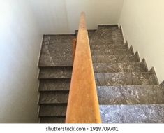 an image of stairs going up to the top floor in a house or office building