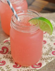 two mason jars filled with watermelon and limeade on top of a table