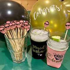 a table topped with drinks and balloons