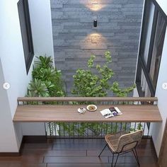 a table and chair on the floor in front of an open door with a plant