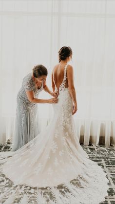 two bridesmaids helping each other get ready for their wedding at the hilton hotel