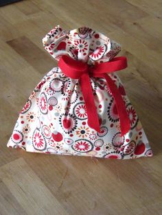 a small bag sitting on top of a wooden floor