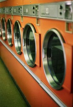 a row of orange washers sitting next to each other