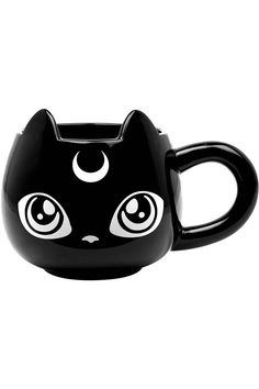 a black cat shaped mug with eyes on it