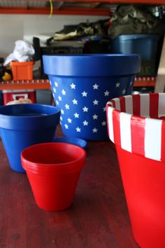 red, white and blue plastic cups sitting on top of a wooden table