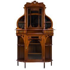 an old fashioned wooden cabinet with glass doors