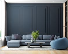 a living room with blue couches and a plant in the center on a coffee table