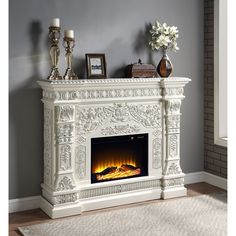 a white fireplace with an electric fire in it