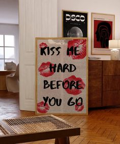 there is a sign that says kiss me hard before you go on the wall in this room