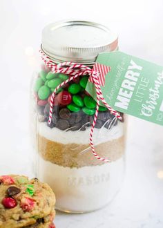 a jar filled with cookies and candy on top of a table