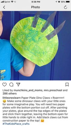 a young boy holding up a paper plate with scissors on it, and the caption reads