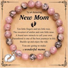 a pink beaded bracelet with an angel charm on it and the words, to an amazing new mom