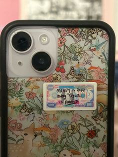 the back of a phone case with flowers on it and a sticker that says money is free