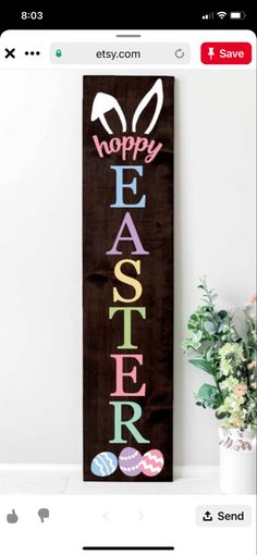 an easter banner hanging on the wall next to a vase with flowers and eggs in it