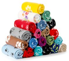 a stack of colorful towels on top of each other in different colors and designs,