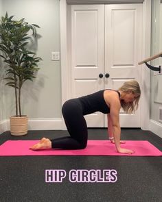 a woman in black shirt doing yoga on pink mat with words hip circles above her