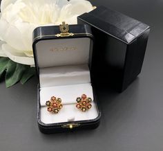 "These 18K yellow gold cluster earrings are set with natural rubies and sapphires creating a floral design. Each cluster is attached so that they are articulated and move subtly with the wearer. The earrings were originally fitted with screw backs, but the owner had them converted to pierced earrings in the 1980s. The posts and push backs are in 14K yellow gold, and stamped 14K. These earrings are truly beautiful and guaranteed to turn heads! To see a complimentary ring from the same estate clic Luxury Floral Cluster Earrings As Gift, Formal Yellow Gold Multi-stone Earrings, Yellow Gold Multi-stone Earrings For Wedding, Yellow Gold Multi-stone Wedding Earrings, Multicolor 22k Gold Earrings For Gifts, Formal Multi-stone Flower-shaped Jewelry, Multicolor Clip-on Earrings For Formal Occasions, Elegant Multicolor 22k Gold Earrings, Gold Gemstone Cluster Earrings For Formal Occasions