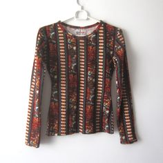 "Vintage Brown Patterned Velvet Blouse Long Sleeve Velvet Top Women's  Velvet Sport Shirt Size Extra Small to Small Rainbow Velour Shirt Estimated size: XS/S Measurements (lying flat): Shoulders: 15\"/ 38 cm Pit to pit: 17\"/ 43 cm stretchy Waist: 13\"/ 33 cm  stretchy Sleeve: 23\"/ 58.5 cm Length: 23\"/ 58.5 cm Please check measurements to insure a proper fit. Remember to allow yourself some extra room for movement. You can compare these with something from your closet that fits you well. This blouse will come to you freshly laundered and ready to wear. Please feel free contact me if you need additional measurements or have any questions Condition: Great Vintage Condition SHIPPING * I ship worldwide via Priority mail (Latvijas Pasts) from Latvia (EU). * I ship from Europe, so please allow Vintage Long Sleeve Tops With Vintage Pattern, Long Sleeve Vintage Tops With Vintage Pattern, Vintage Long-sleeve Printed Tops, Vintage Long Sleeve Printed Tops, Vintage Long Sleeve Printed T-shirt, Vintage Printed Long Sleeve Tops, Casual Long Sleeve Tops With Vintage Pattern, Vintage Patterned Long Sleeve Tops, Vintage Long Sleeve Patterned Tops