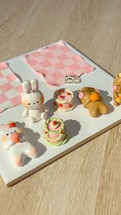 there are many small toy animals on the tray