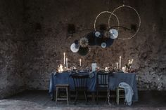 the table is set with candles, plates and napkins for two people to eat