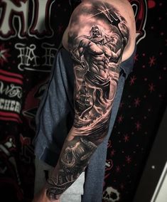 a man with a full sleeve tattoo on his arm