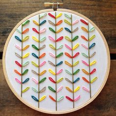 a cross stitch pattern with colorful arrows on it