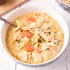 a white bowl filled with chicken noodle soup