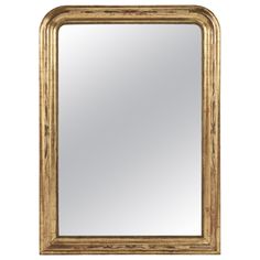 an ornate gold framed mirror on a white background