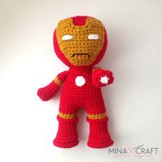 a crocheted iron man doll is posed on a white background with the caption's name below it