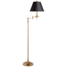 an antique brass floor lamp with a black shade on the base and a white background