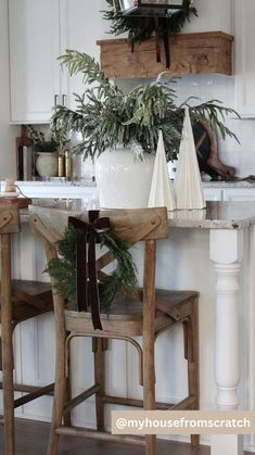 a table with two chairs and a potted plant sitting on it's side