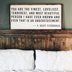 a bed with white pillows and a framed sign above it that says you are the finest, loveless, tenderest, and most beautiful person i have ever known