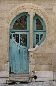 a blue door with two arched glass windows