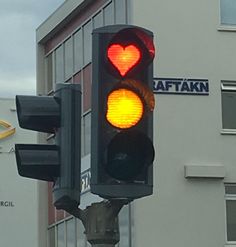 a traffic light with a red heart on it