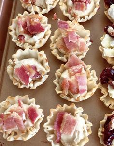 many small pastries are lined up on a baking sheet and ready to be eaten