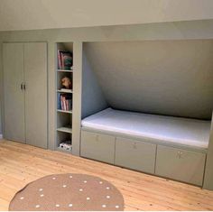 a bedroom with a bed, bookshelf and cupboards in the corner on the floor