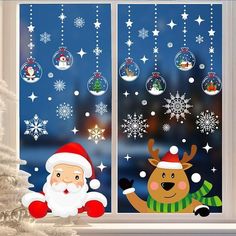 santa claus and reindeer looking out the window with snowflakes hanging from it's sides