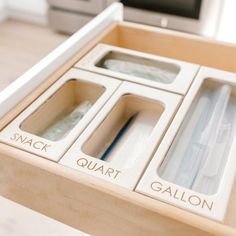 the drawers are labeled with quart and gallon's in each drawer for storage