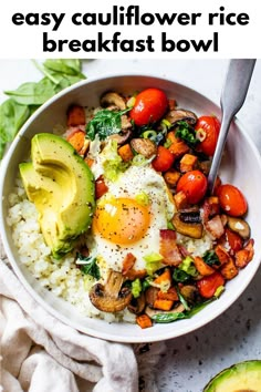 a bowl filled with rice and vegetables next to an avocado on the side