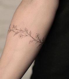 a woman's arm with a flower tattoo on the left side of her arm