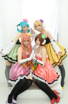 four women dressed in costumes posing for a photo