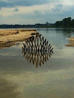 a wooden structure sitting in the middle of a body of water