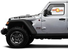 a silver jeep with an orange sticker on it's side window and door